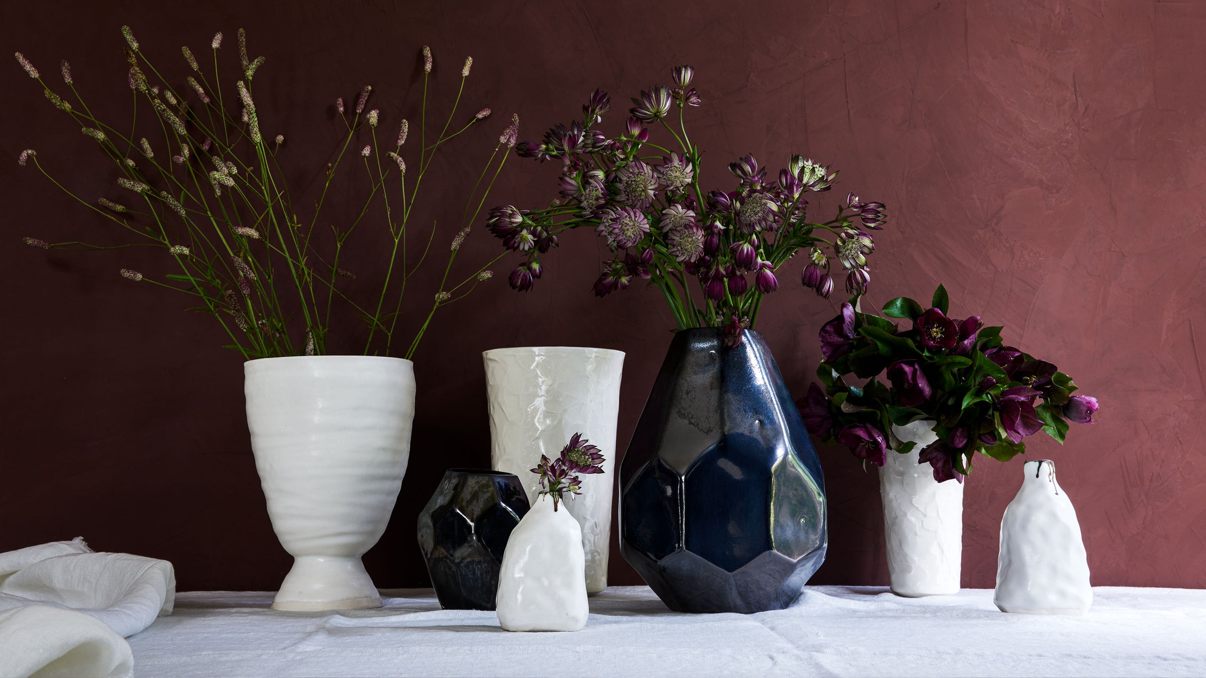 DBO HOME artisan luxury ceramic vases in white and black glaze with winter plants and flowers