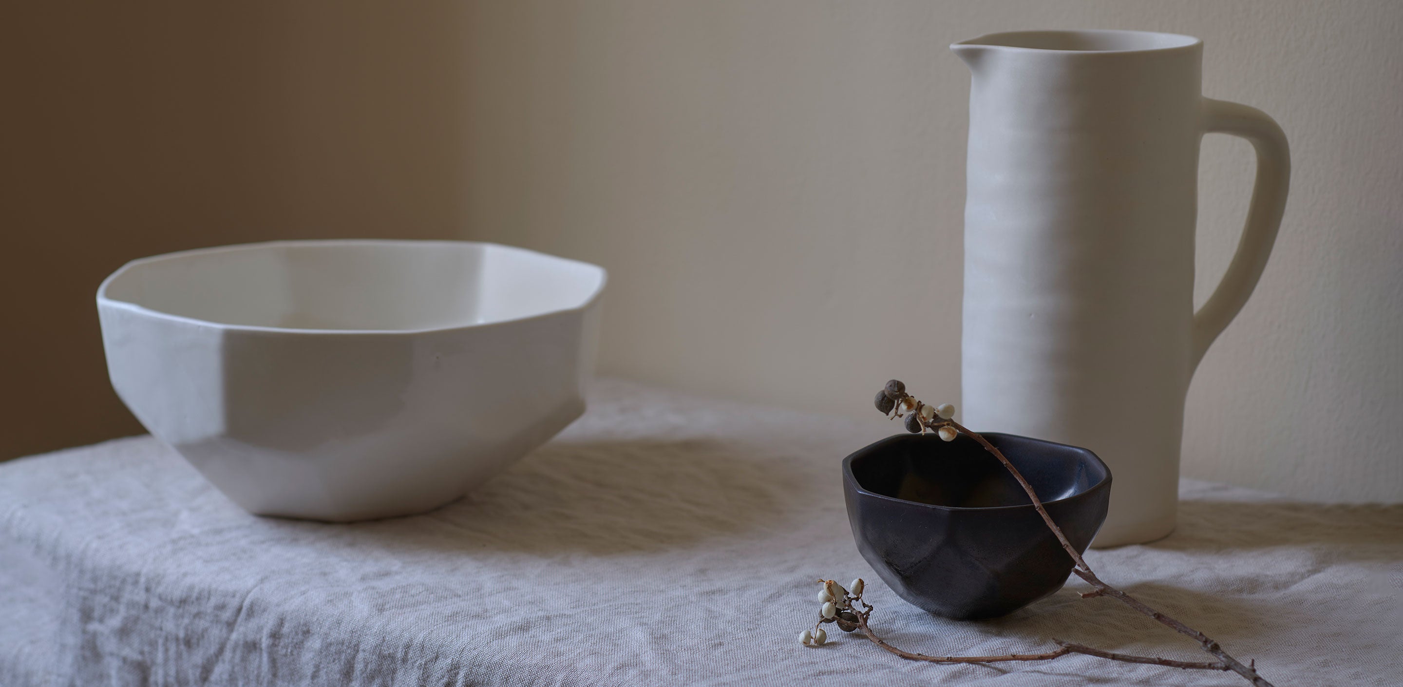 Brittany Albert + John Gruen Tastemakers' Table | Warm colored handbuilt ceramics on a white shelf