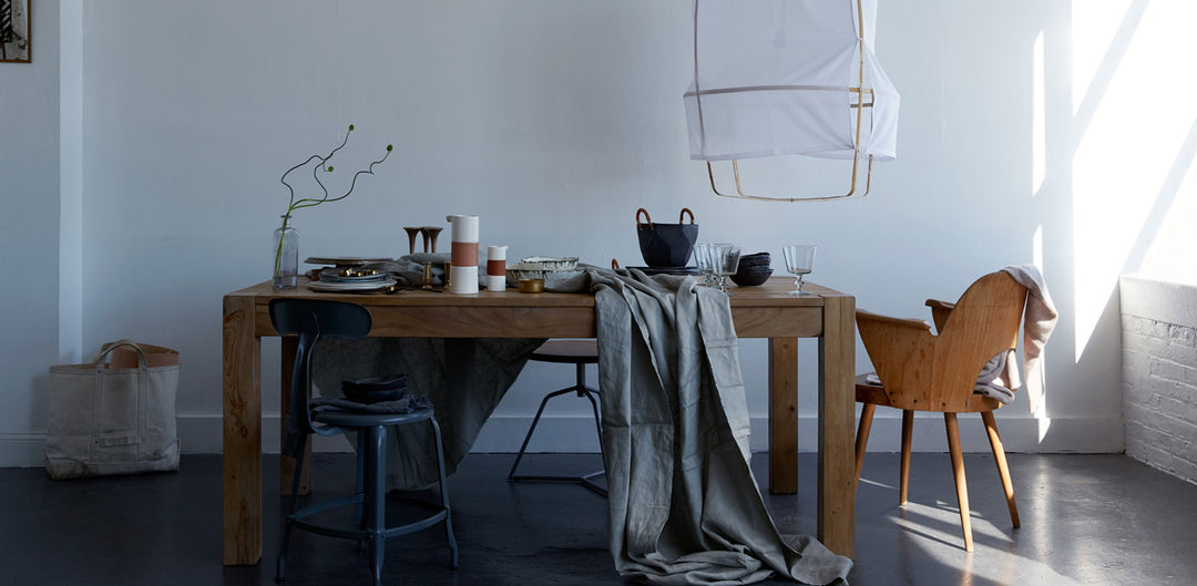 Dane Tashima Emily Rickard Spontaneous Gathering Tastemakers Table with DBO HOME ceramic ice buck and porcelain pitchers on a wooden table with gray cloth and sunlight