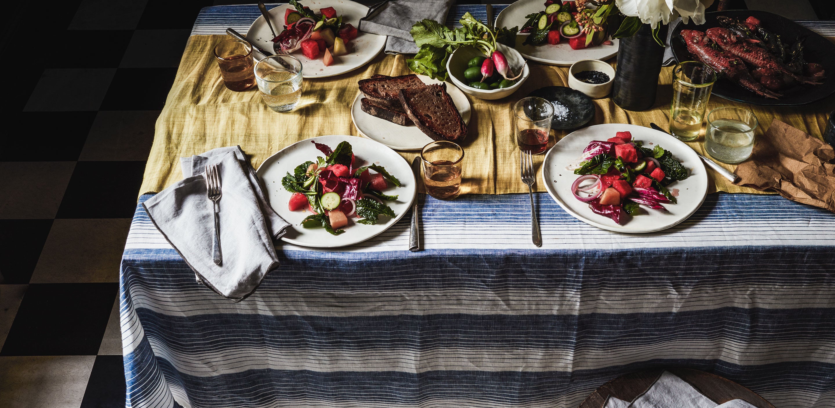 Sarah Smart Summer Love Tastemakers Table with DBO HOME bare white artisan ceramic dinner plates on a table set with colorful tablecloth, vegetables, bread