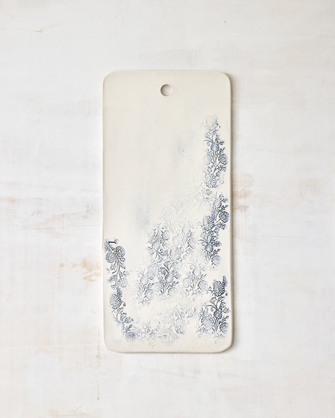 Handmade Kashmir charcuterie board in white porcelain with blue floral pattern, rectangular serving board for cheese, bread, and appetizers.