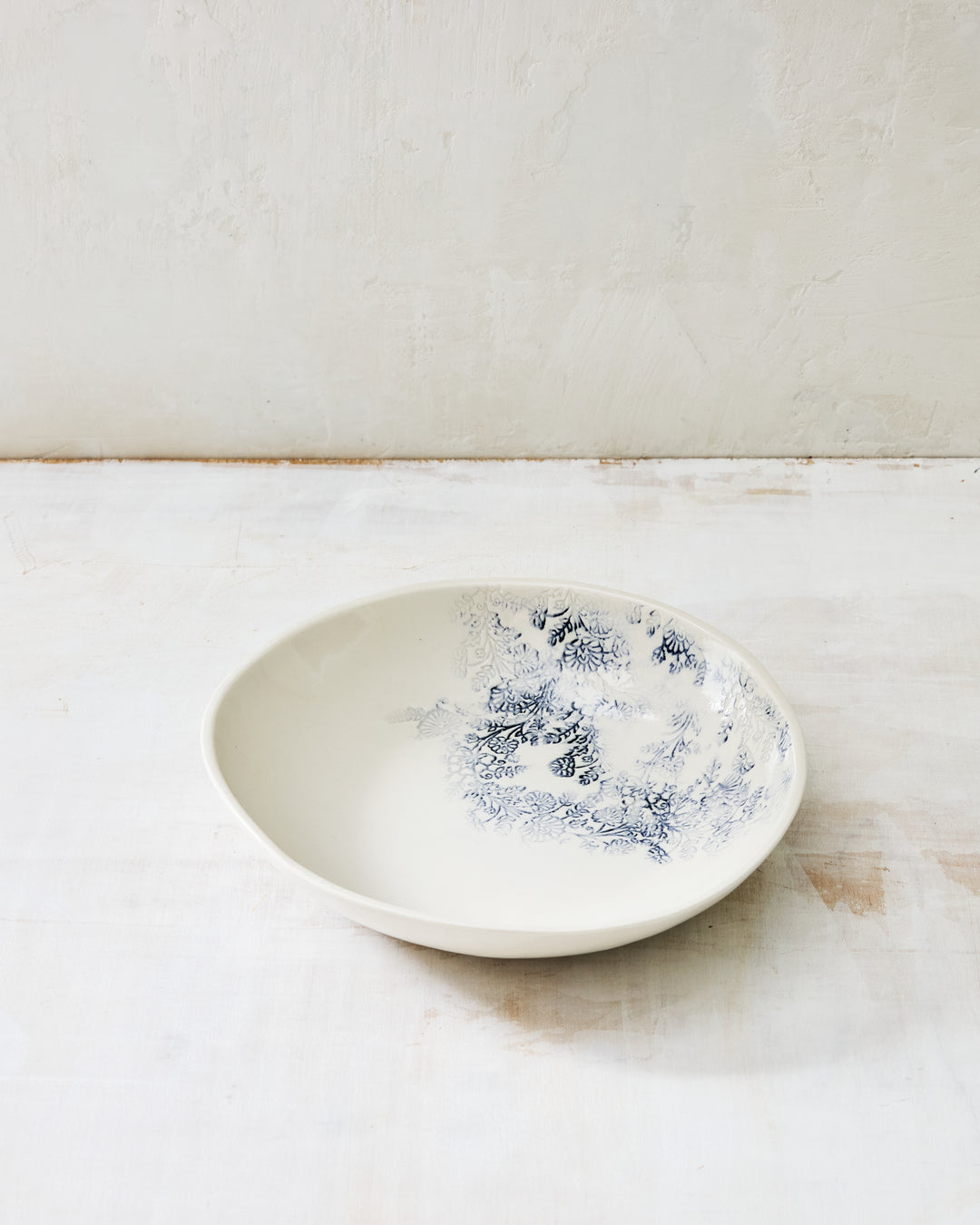 Handbuilt Kashmir Everything Bowl featuring a soft oval form and indigo botanical pattern inside the bowl.