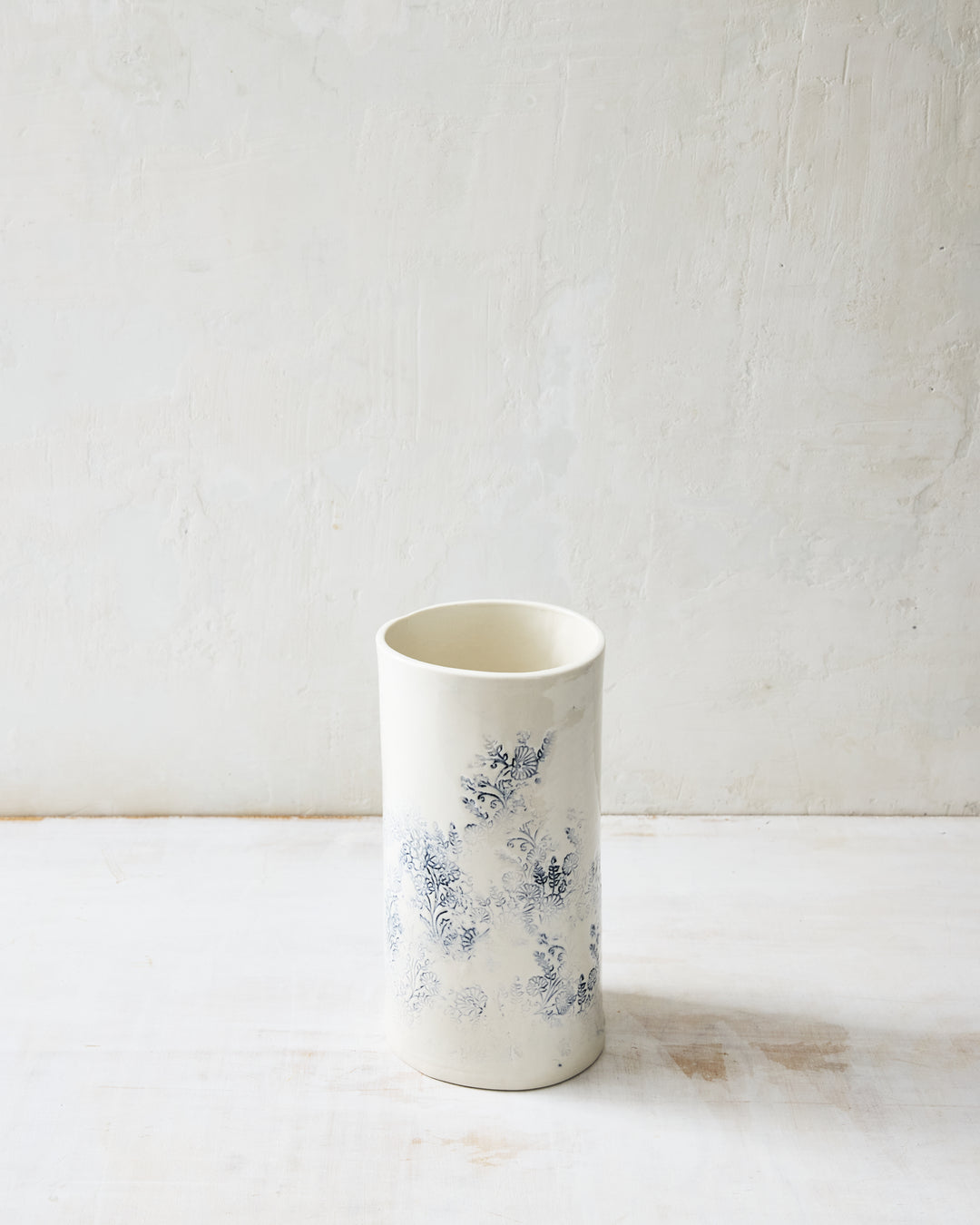 Handcrafted Kashmir small porcelain vase featuring blue indigo floral motif on white glaze, decorative ceramic vase for fresh or dried flowers.
