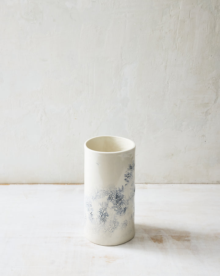 Kashmir small porcelain vase with subtle indigo floral pattern on white glaze, handcrafted ceramic vessel shown from the back