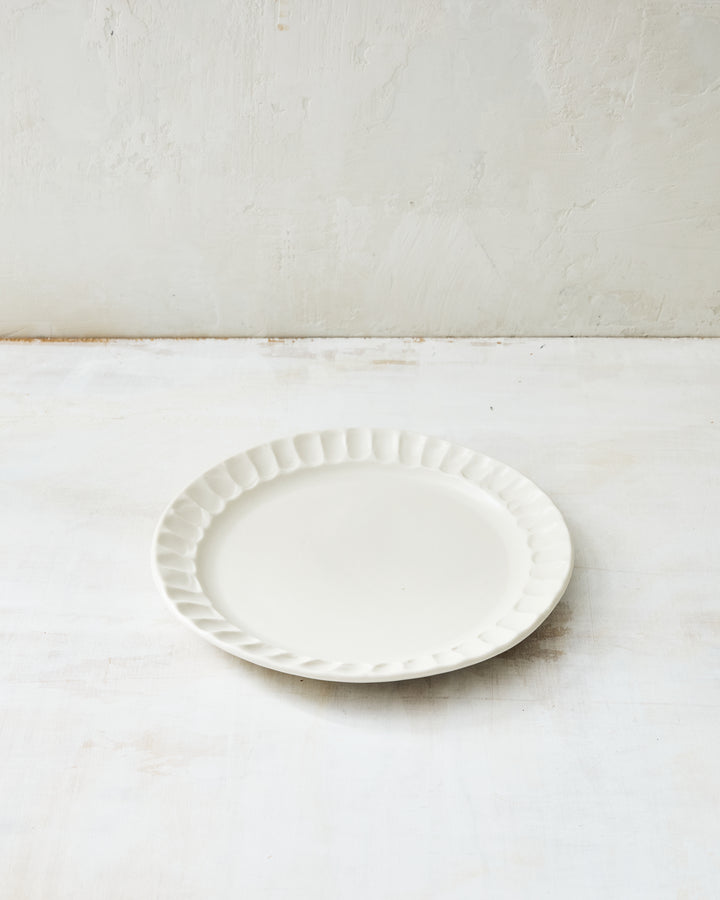 DBO HOME Nonna Salad Plate in white porcelain with a shimmering satin glaze finish and gently fluted rim. This ceramic side plate brings quiet beauty to everyday meals or elegant gatherings.