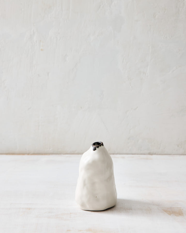 Handcrafted in porcelain, the DBO HOME Paul Pinch Bud Vase features a gently rounded form with a dark bronze rim and organic pinch marks. A minimal bud vase with soulful, earthy character.