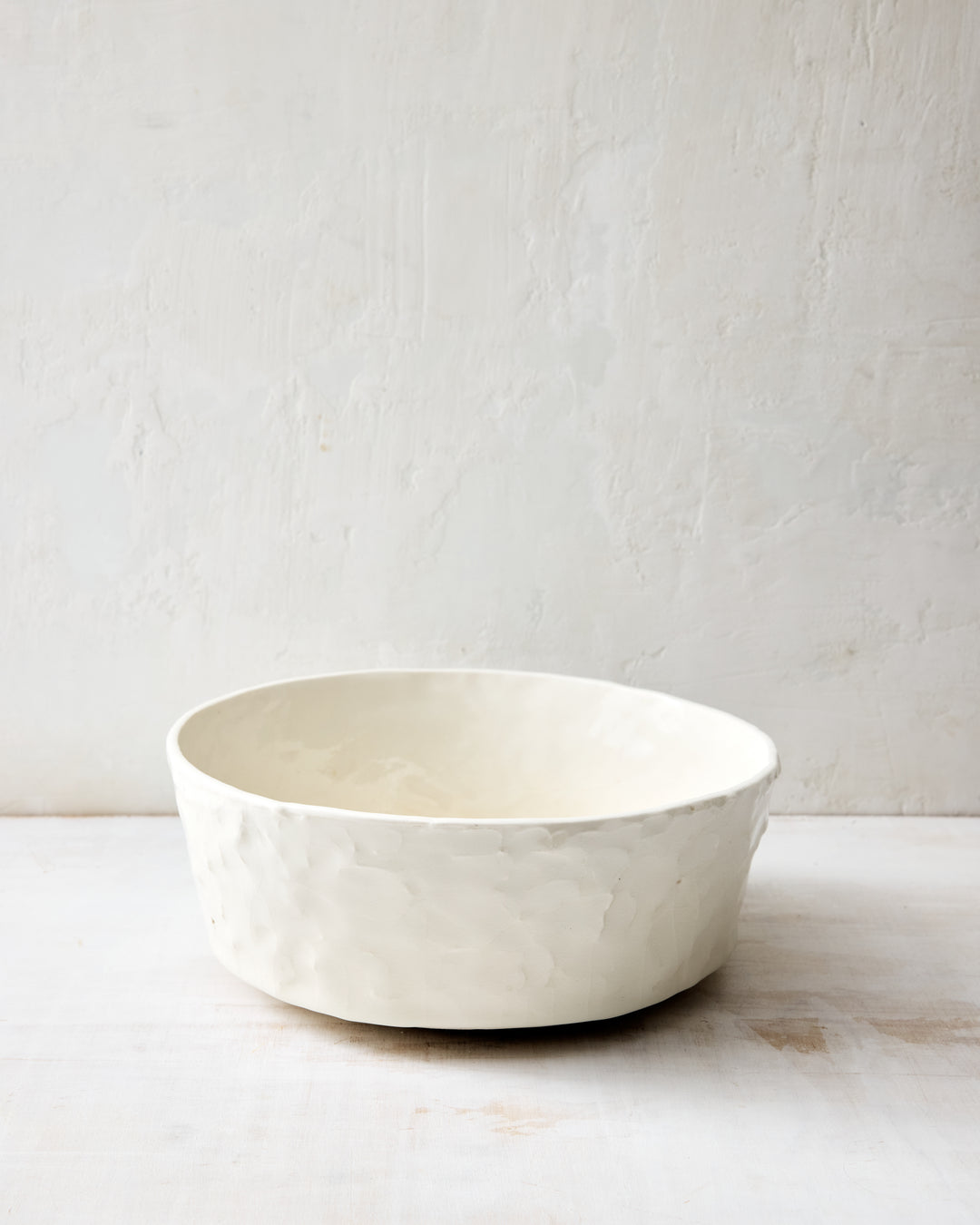DBO HOME Stucco Salad Bowl in handmade porcelain with a tactile stucco-textured exterior, front view showing the clean simple form, photographed on a whitewashed surface.
