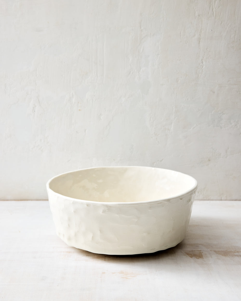DBO HOME Stucco Salad Bowl in handmade porcelain with a tactile stucco-textured exterior, back view showing the sculptural texture and form.
