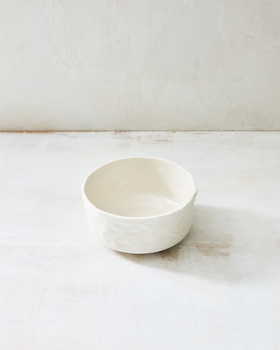 DBO HOME Stucco Straight Bowl in clear-glazed handmade porcelain with a straight-sided cylindrical form and tactile stucco-textured exterior, photographed on a whitewashed surface.