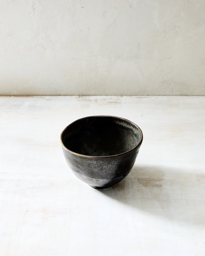 DBO HOME Wabi Rice Bowl in Granite glaze, handmade porcelain with a rounded form, layered mussel and snowflake glaze, and stone-like surface texture, photographed on a whitewashed surface.