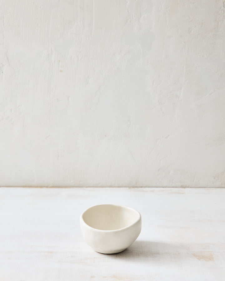 DBO HOME Wabi Salt Cellar in Foam glaze, handmade porcelain with a subtle white-on-white layered glaze and stone-like surface texture, photographed on a whitewashed surface.