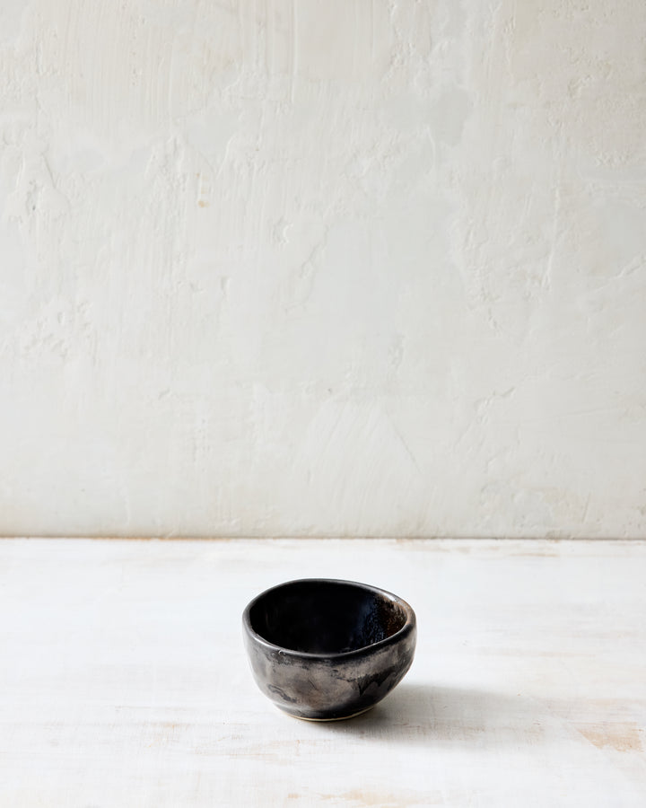 DBO HOME Wabi Salt Cellar in Granite glaze, handmade porcelain with a layered mussel and snowflake glaze and stone-like surface texture, photographed on a whitewashed surface.