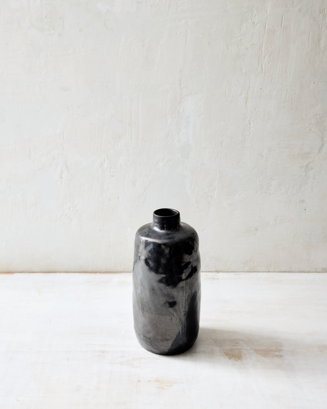 Medium Wabi ceramic vase in dark Granite glaze, showcasing a smoky charcoal and gray surface with organic variation, handcrafted form, and minimalist studio styling.