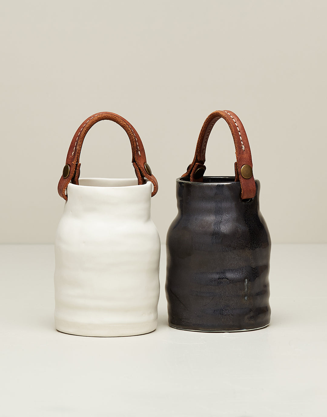 DBO HOME Handmade black and white ceramic utility vessels with hand stitched leather handles