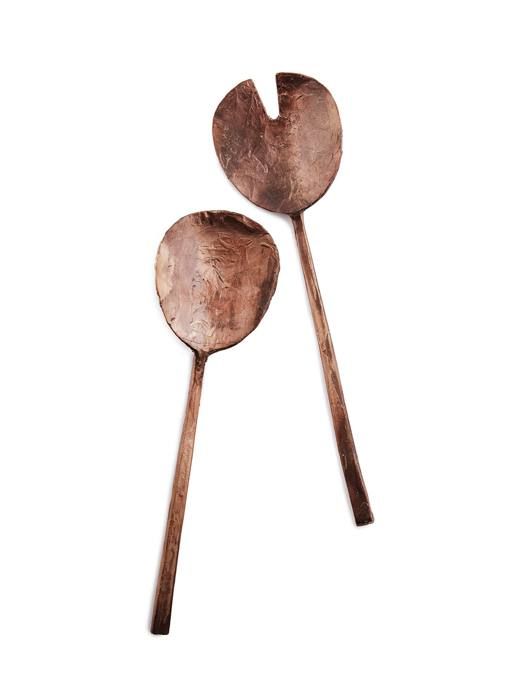 Handcast artisan bronze serving utensils on white background