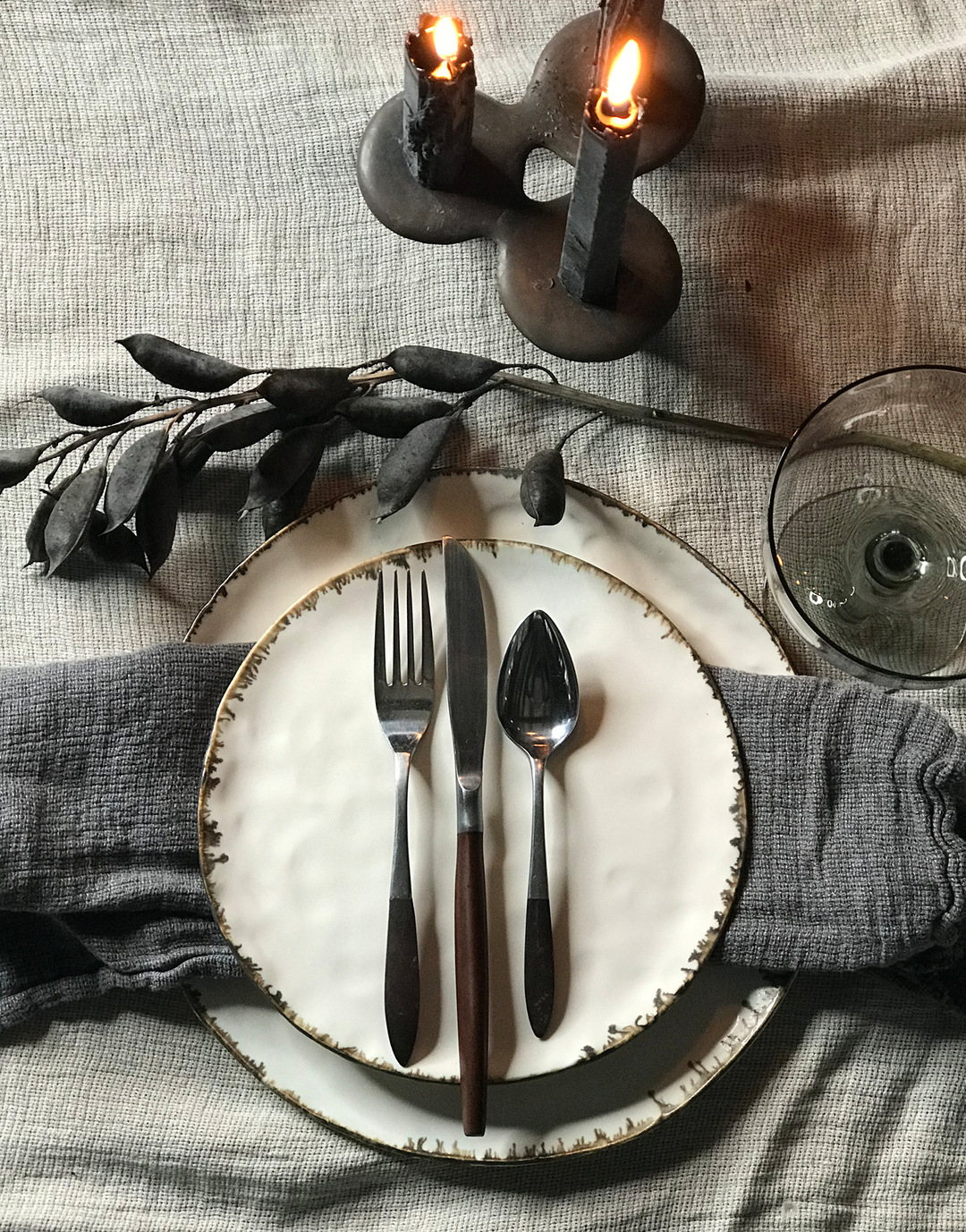 Pinch handmade ceramic dinner plate set from dbo home with natural textured edges, on linen cloth with vintage glassware and bronze candlesticks