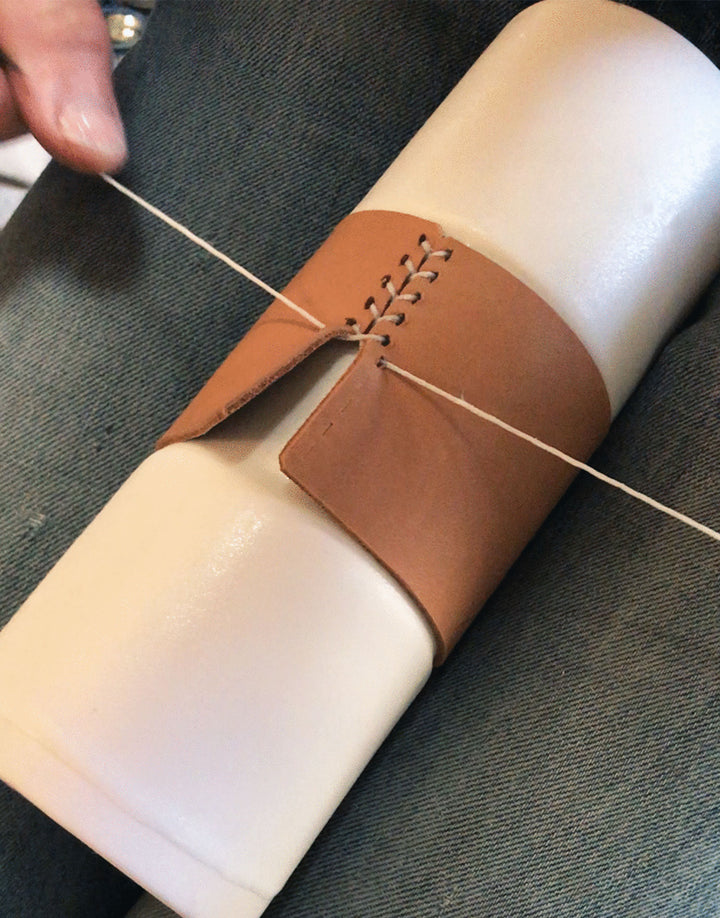 Behind the scenes photo of leather handstitching process